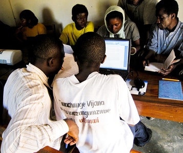 refugees looking at computers